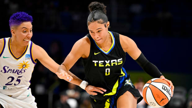 Wings forward Satou Sabally dribbles and drives to the basket past Sparks guard Layshia Clarendon.